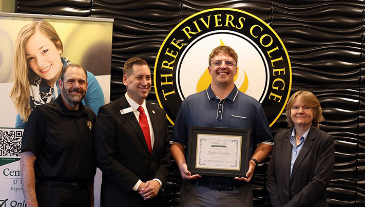 Dylan Bratcher with school officials