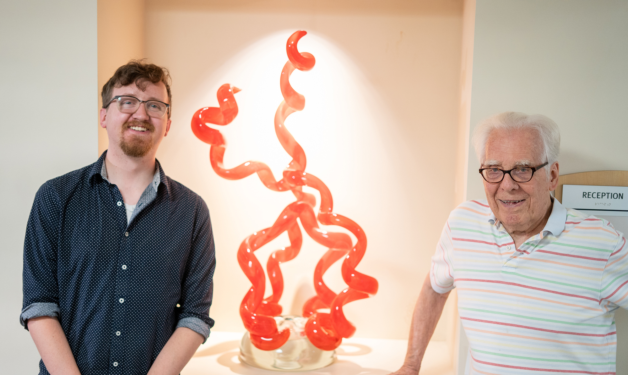 Tyler Pierson and Dr. Joe Geist with Chihuly glass art